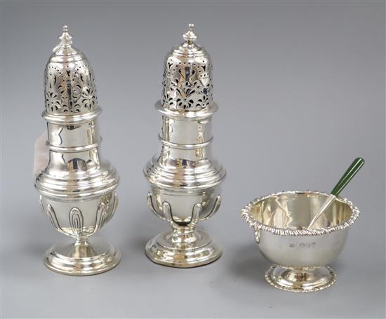 A pair of George V silver sugar castors, London, 1930, (a.f.), with loaded bases, 19.7cm.
